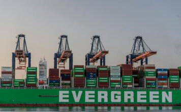 US Trade Deficit Stabilizes as Post-Tariff ‘Front-Loading’ Fades massive cargo ship at rotterdam port in sunset
