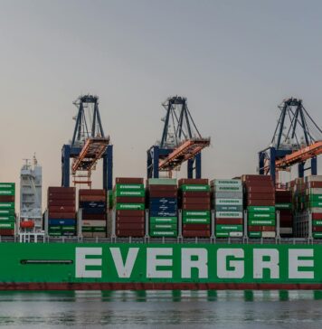 US Trade Deficit Stabilizes as Post-Tariff ‘Front-Loading’ Fades massive cargo ship at rotterdam port in sunset