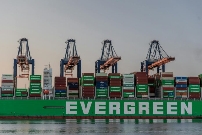 massive cargo ship at rotterdam port in sunset